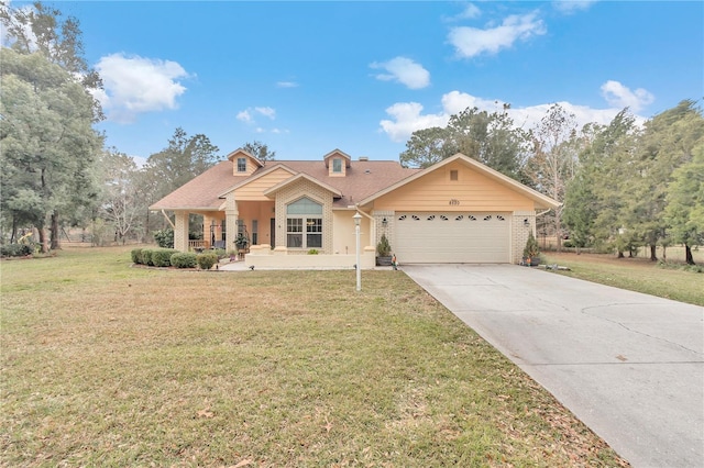 view of front of property with covered porch, a garage, and a front lawn