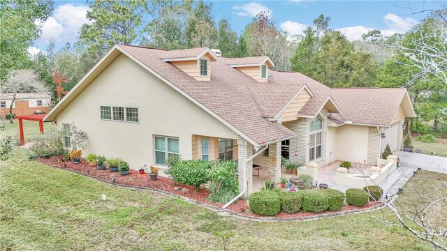 view of front of property with a patio and a front yard