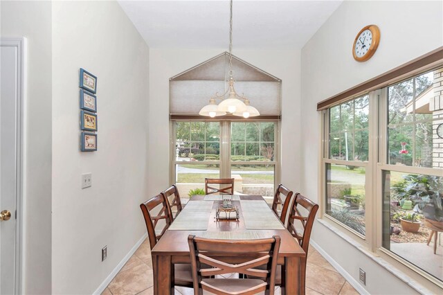 dining room featuring light tile patterned floors, an inviting chandelier, and baseboards