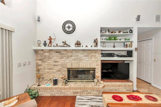 living area featuring a fireplace and wood finished floors