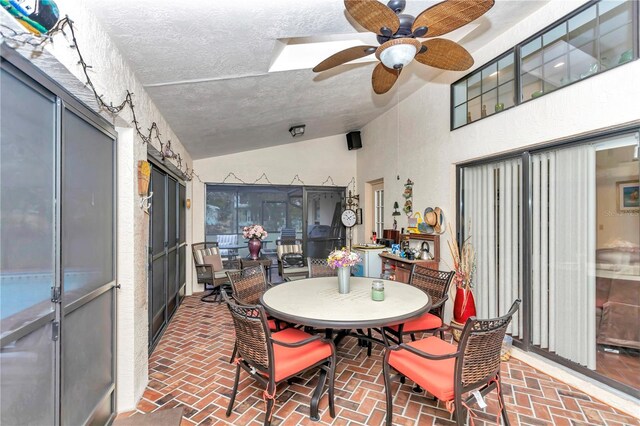 sunroom / solarium featuring a ceiling fan and lofted ceiling