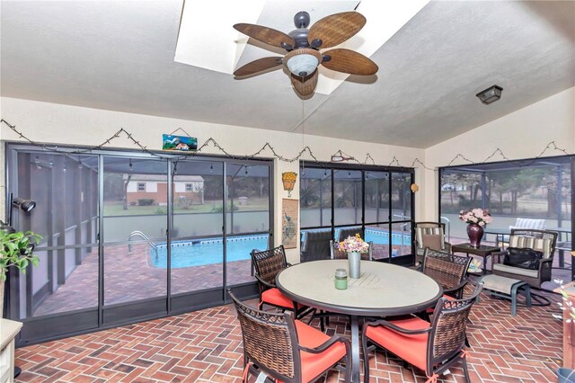 sunroom / solarium featuring vaulted ceiling and a ceiling fan