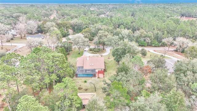 drone / aerial view featuring a wooded view