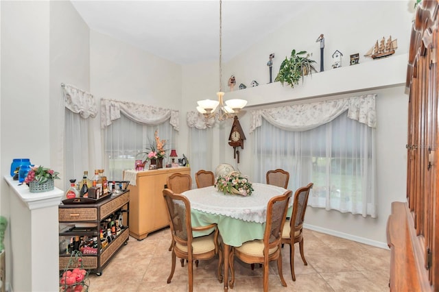 dining room featuring a chandelier, baseboards, and tile patterned floors