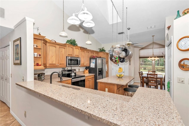 kitchen with open shelves, appliances with stainless steel finishes, a sink, and light stone countertops