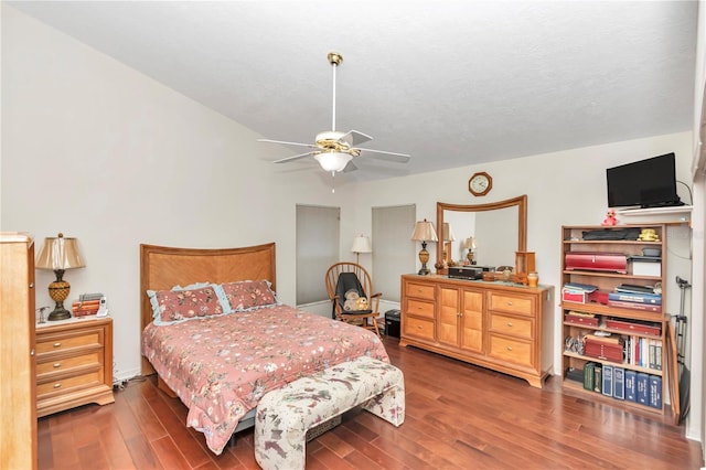 bedroom featuring ceiling fan, a textured ceiling, and wood finished floors