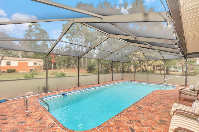 pool featuring a patio and glass enclosure