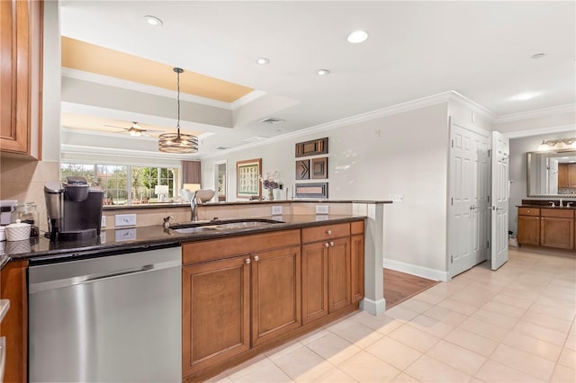 kitchen featuring a raised ceiling, crown molding, ceiling fan, sink, and stainless steel dishwasher