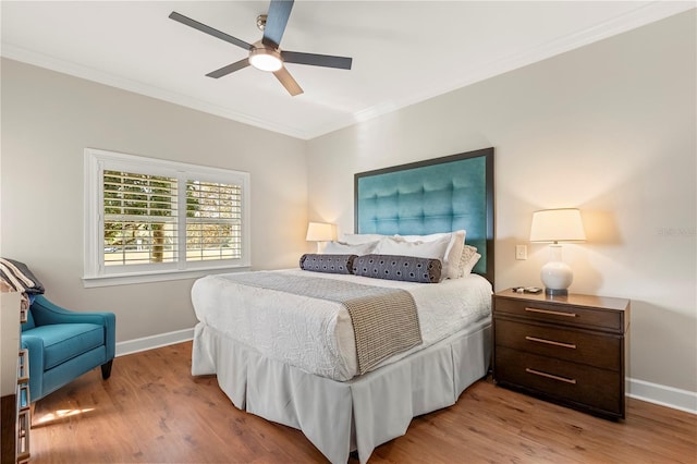 bedroom with ceiling fan, crown molding, and light hardwood / wood-style floors