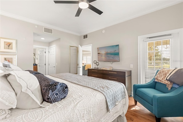 bedroom featuring ornamental molding, ceiling fan, and light hardwood / wood-style floors