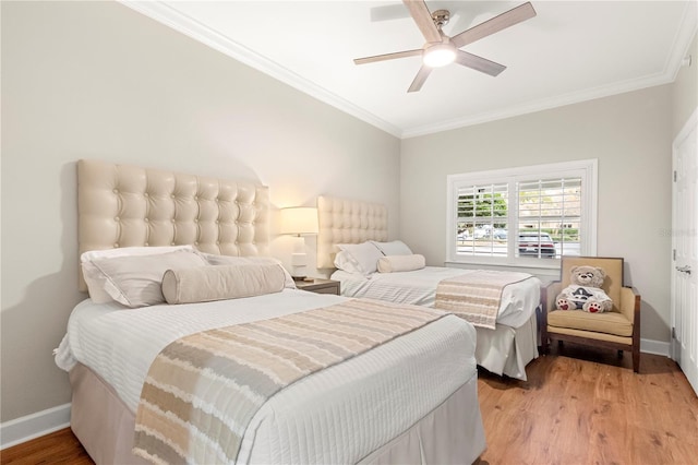 bedroom featuring ornamental molding, ceiling fan, and light wood-type flooring