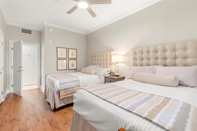 bedroom with ceiling fan, crown molding, and light hardwood / wood-style floors