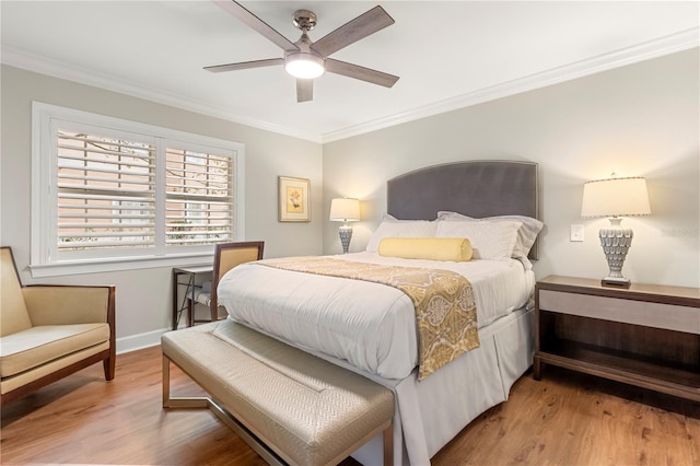 bedroom featuring ceiling fan, crown molding, and wood-type flooring