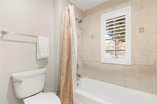 bathroom with toilet and shower / bath combo