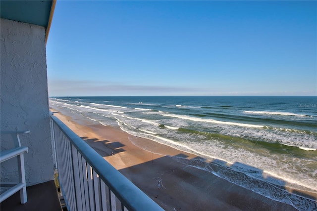 balcony with a beach view and a water view