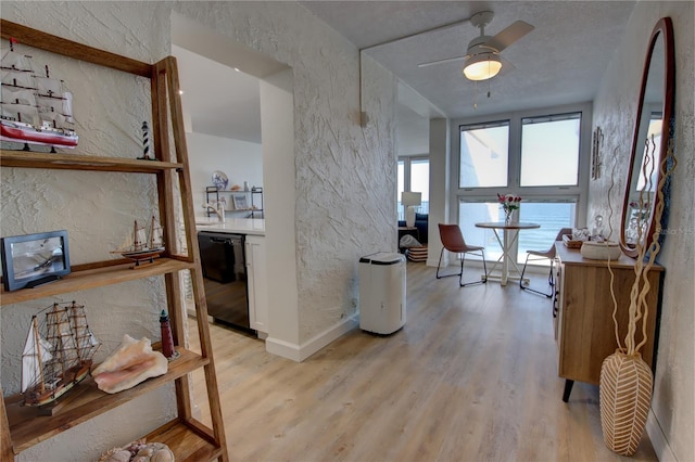 corridor with light hardwood / wood-style floors