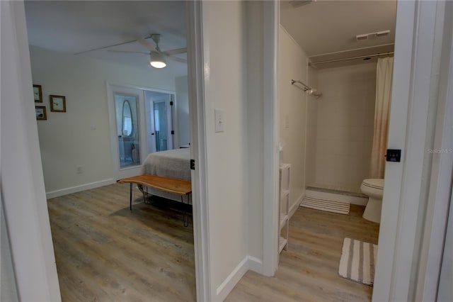 bathroom featuring toilet, ceiling fan, hardwood / wood-style floors, and a shower with shower curtain