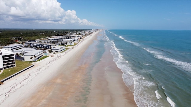 birds eye view of property with a water view and a view of the beach