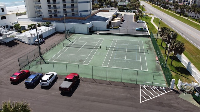 view of sport court with a water view