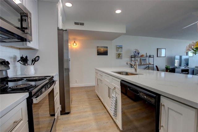 5203 S Atlantic Ave Unit 815B, New Smyrna Beach, FL 32169 - kitchen with light countertops, visible vents, a sink, decorative backsplash, and black appliances