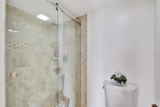 bathroom featuring toilet and tiled shower