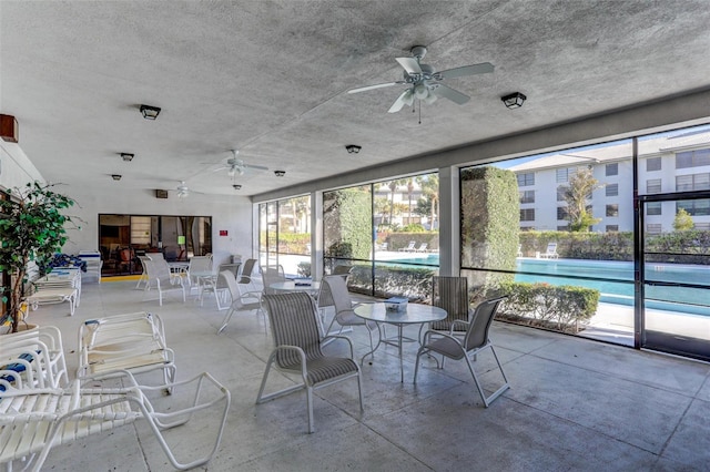 interior space with ceiling fan