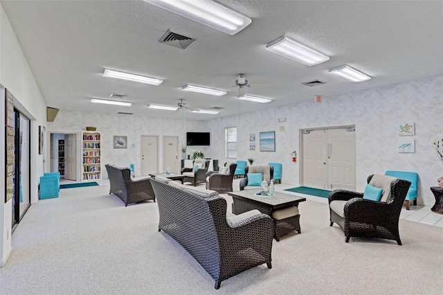 interior space featuring ceiling fan and a textured ceiling