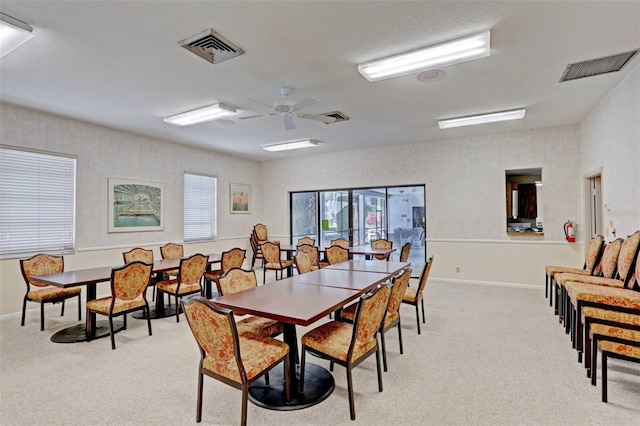 dining room featuring ceiling fan and light colored carpet