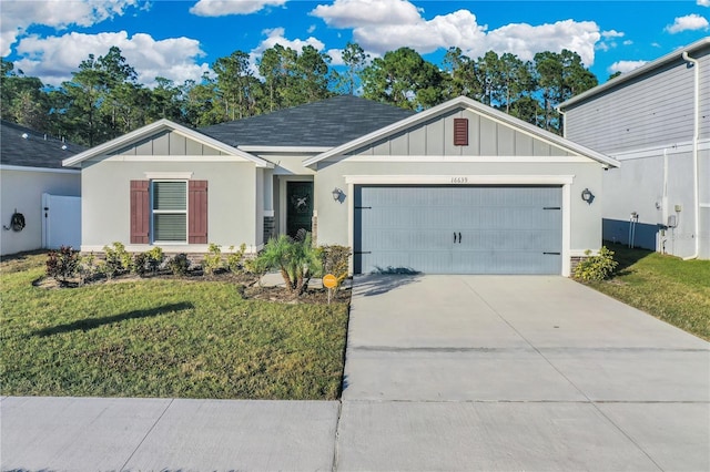 view of front of home featuring a front yard and a garage