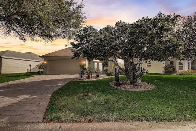 view of front of property featuring a lawn and a garage