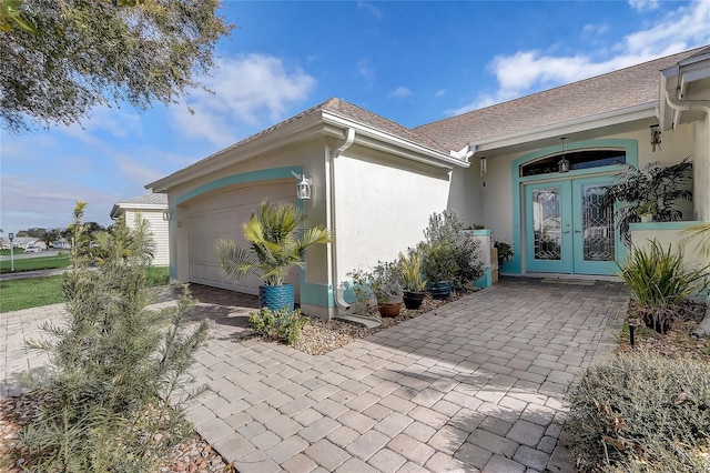 view of patio / terrace featuring french doors and a garage