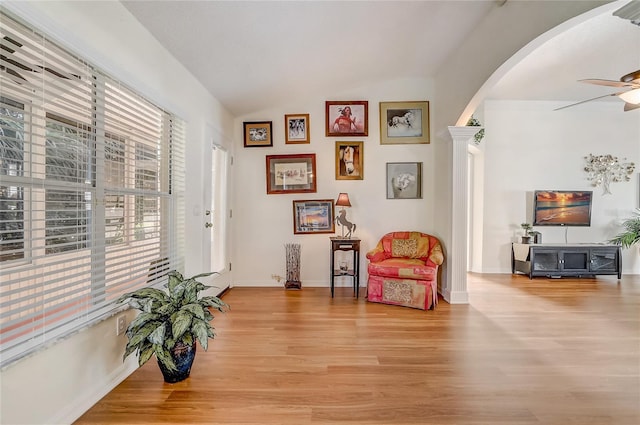 sitting room featuring ceiling fan, lofted ceiling, and light wood-type flooring