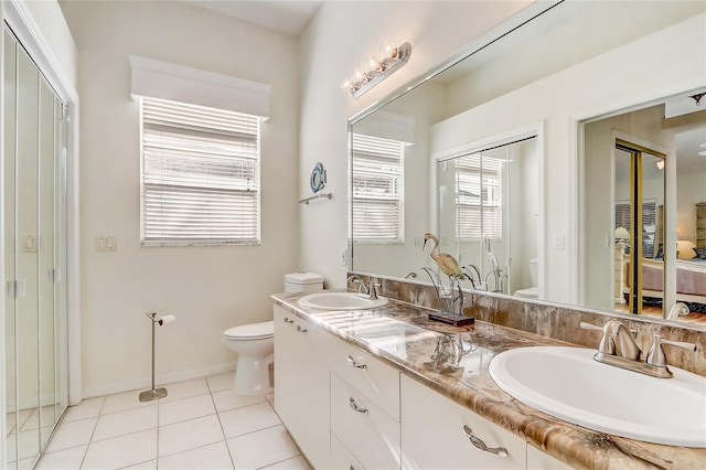 bathroom with tile patterned floors, vanity, and toilet