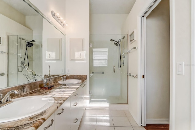 bathroom with tile patterned flooring, vanity, and walk in shower