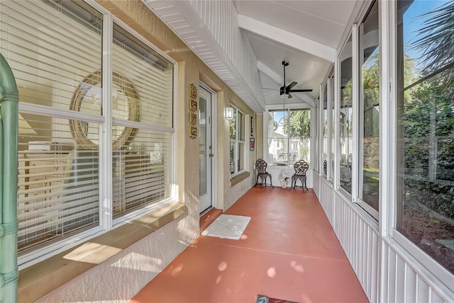 unfurnished sunroom with ceiling fan and lofted ceiling