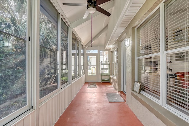 unfurnished sunroom with ceiling fan and vaulted ceiling