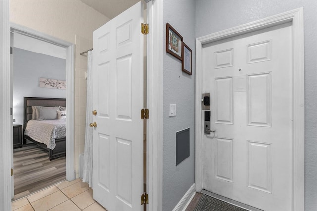 hallway featuring light tile patterned floors