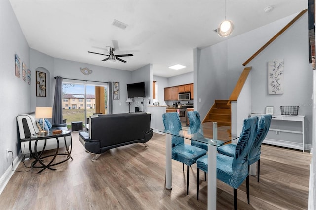 dining area with light hardwood / wood-style flooring and ceiling fan