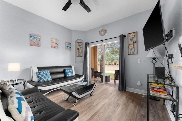 living room with ceiling fan and hardwood / wood-style flooring