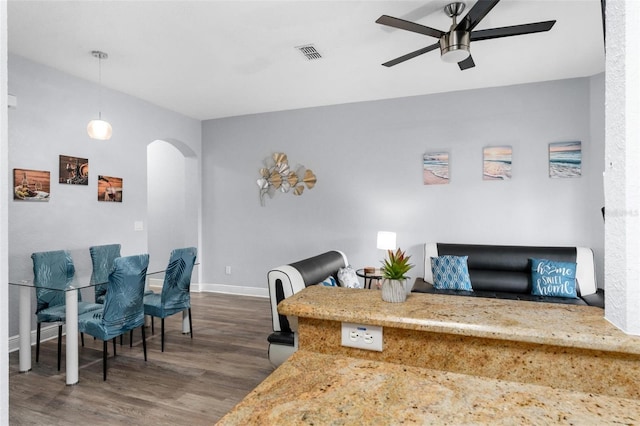 dining space with dark hardwood / wood-style flooring and ceiling fan