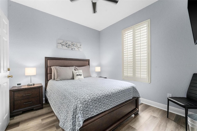 bedroom with ceiling fan and light wood-type flooring