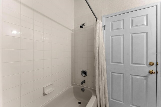 bathroom with shower / bath combination with curtain