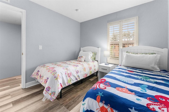 bedroom with hardwood / wood-style flooring