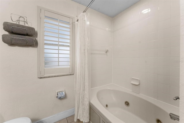 bathroom with tile patterned flooring, shower / bath combo, and toilet