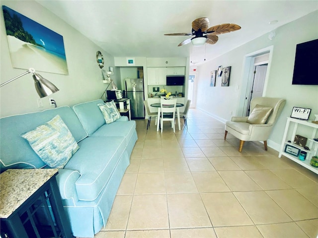 living room with light tile patterned floors and ceiling fan