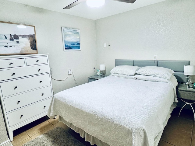 tiled bedroom with ceiling fan