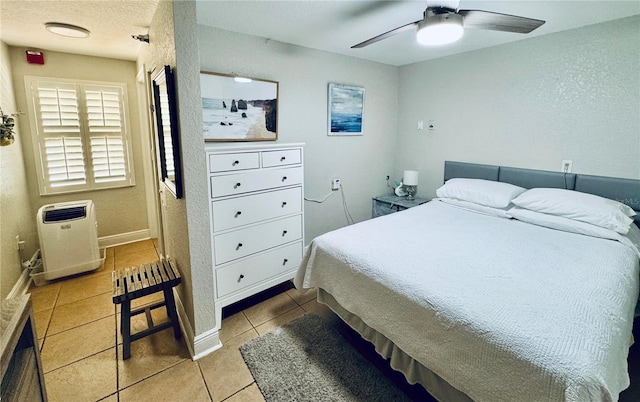 tiled bedroom with ceiling fan