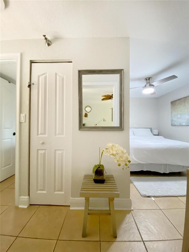 tiled bedroom with ceiling fan