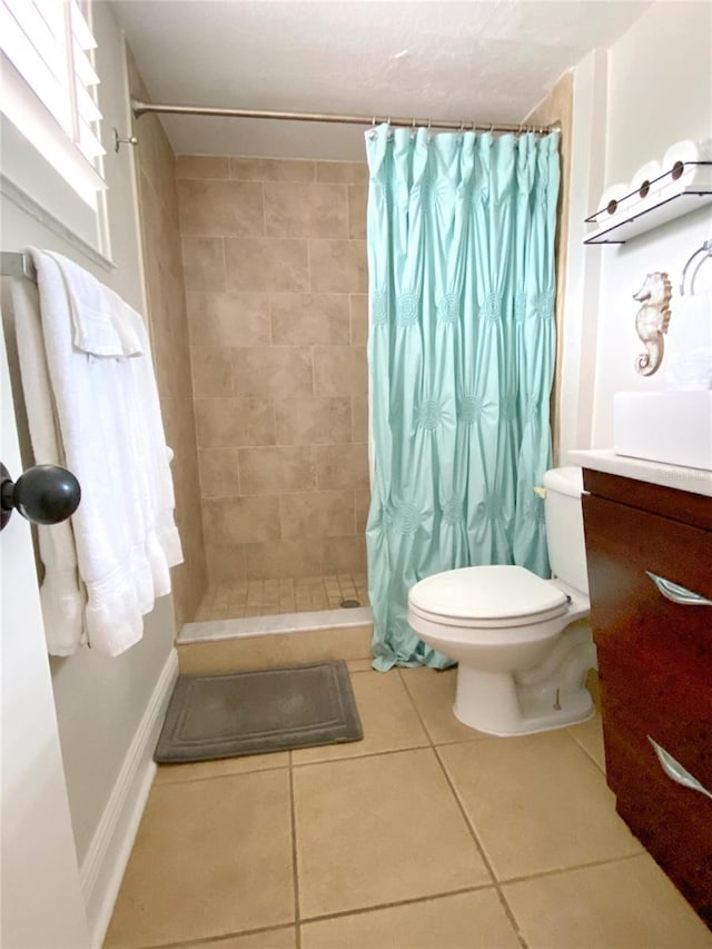 bathroom with tile patterned flooring, toilet, vanity, and a shower with curtain