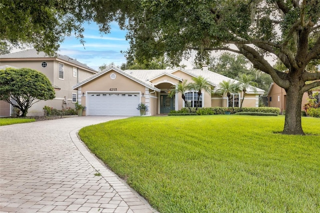 ranch-style house with a front yard and a garage